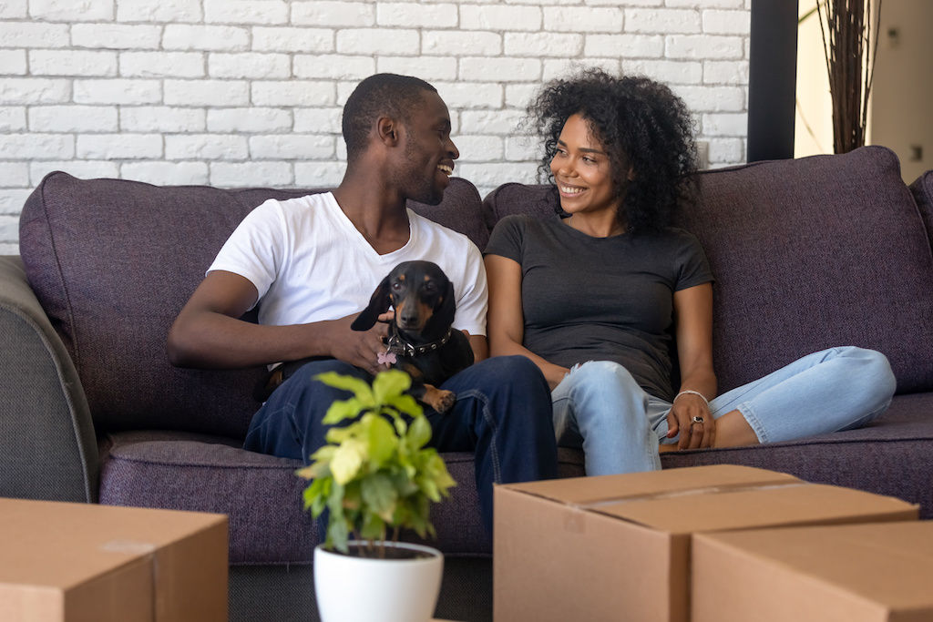 Young couple in new apartment with a dog